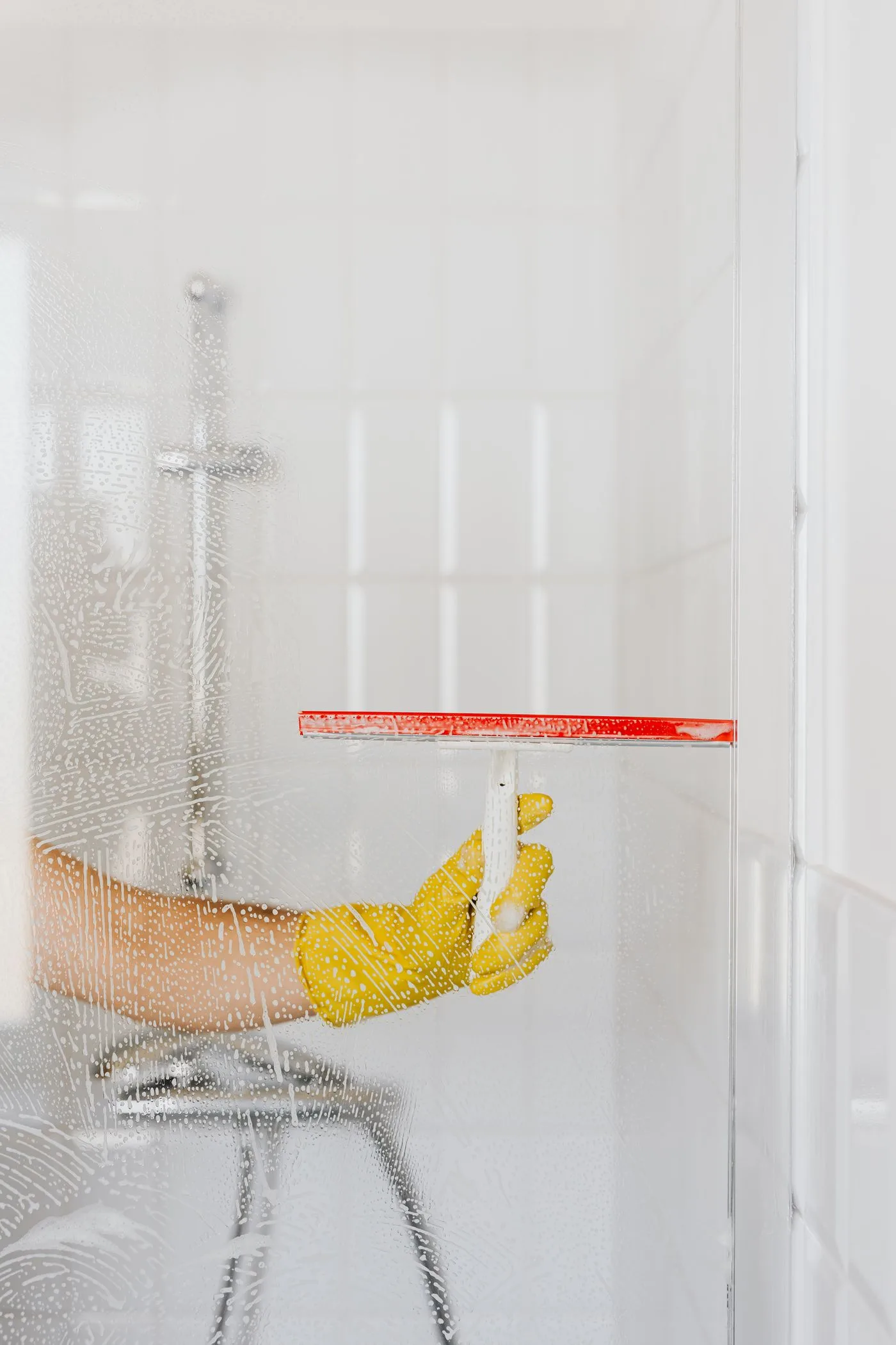 Cleaning shower glass with a squeegee