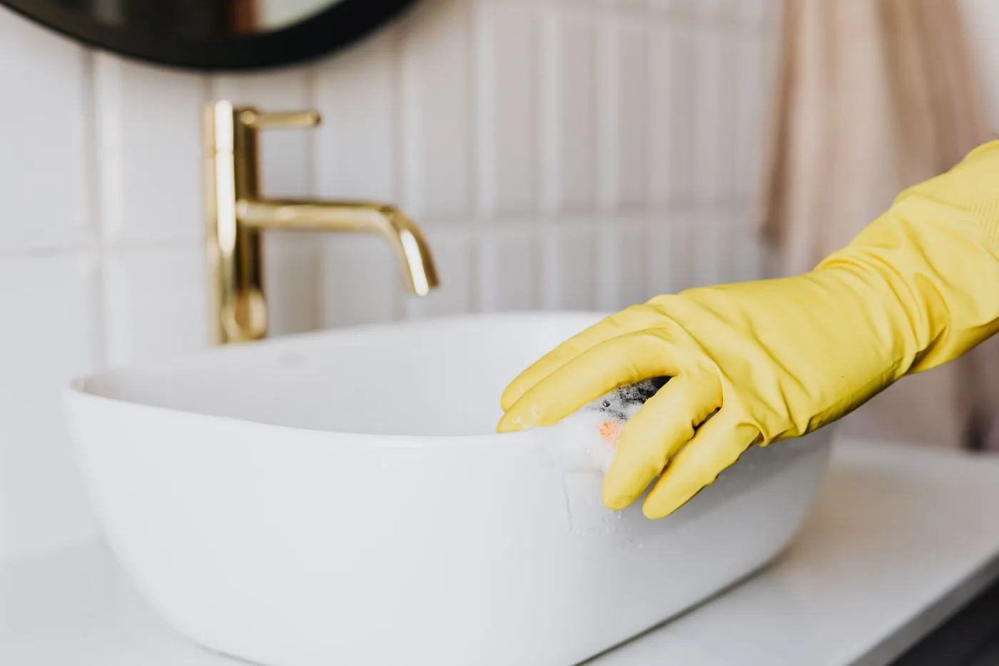 Wiping the outside of a bathroom basin