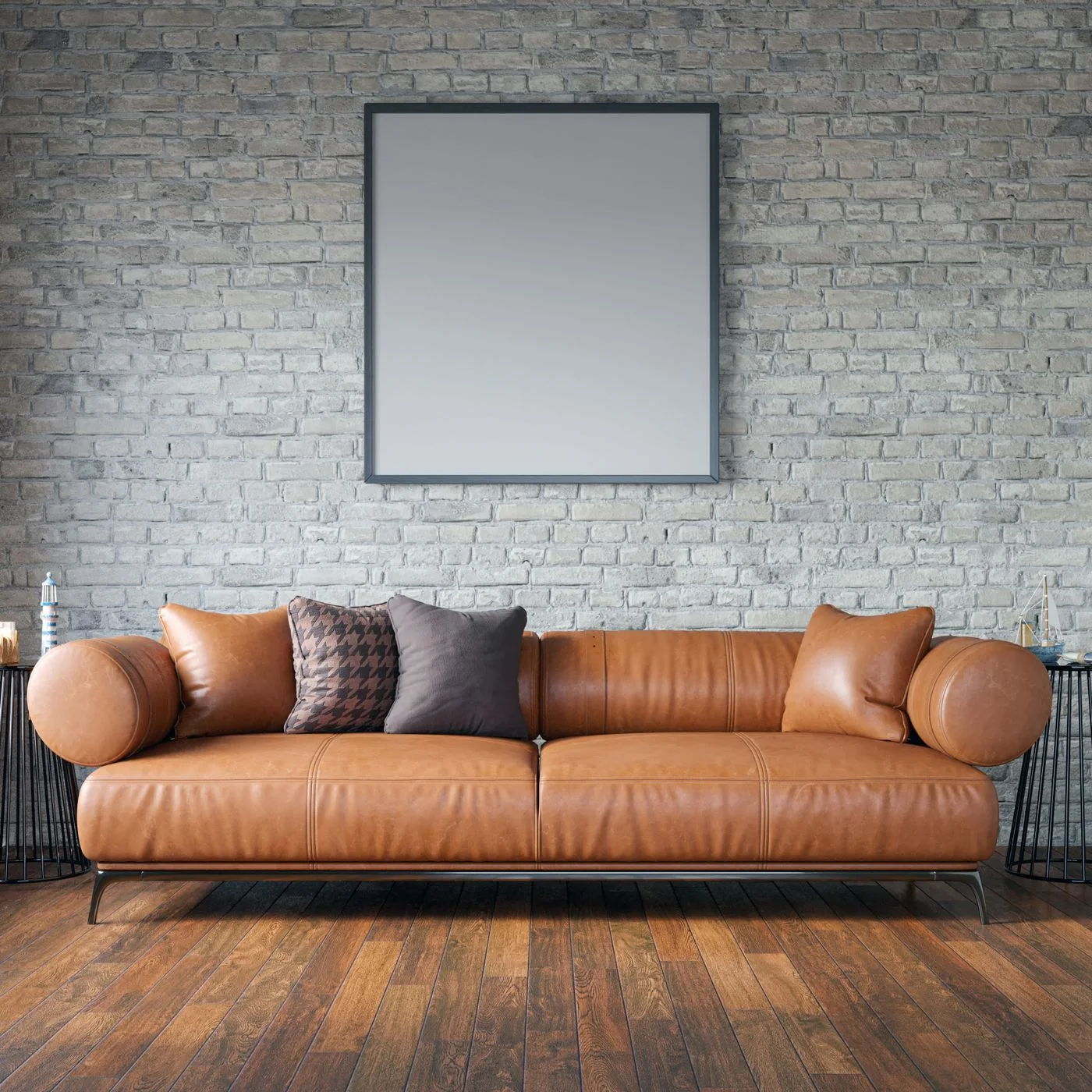 Leather sofa beside a brick wall