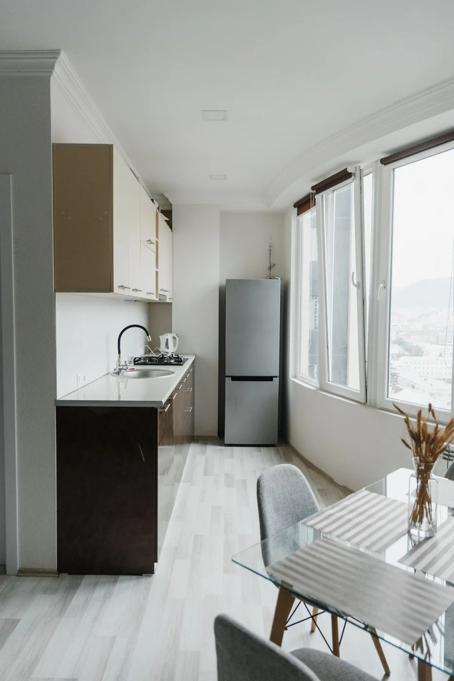 Refrigerator beside kitchen cabinets