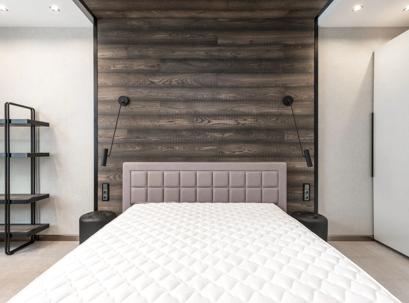Uncovered white mattress on a bed
