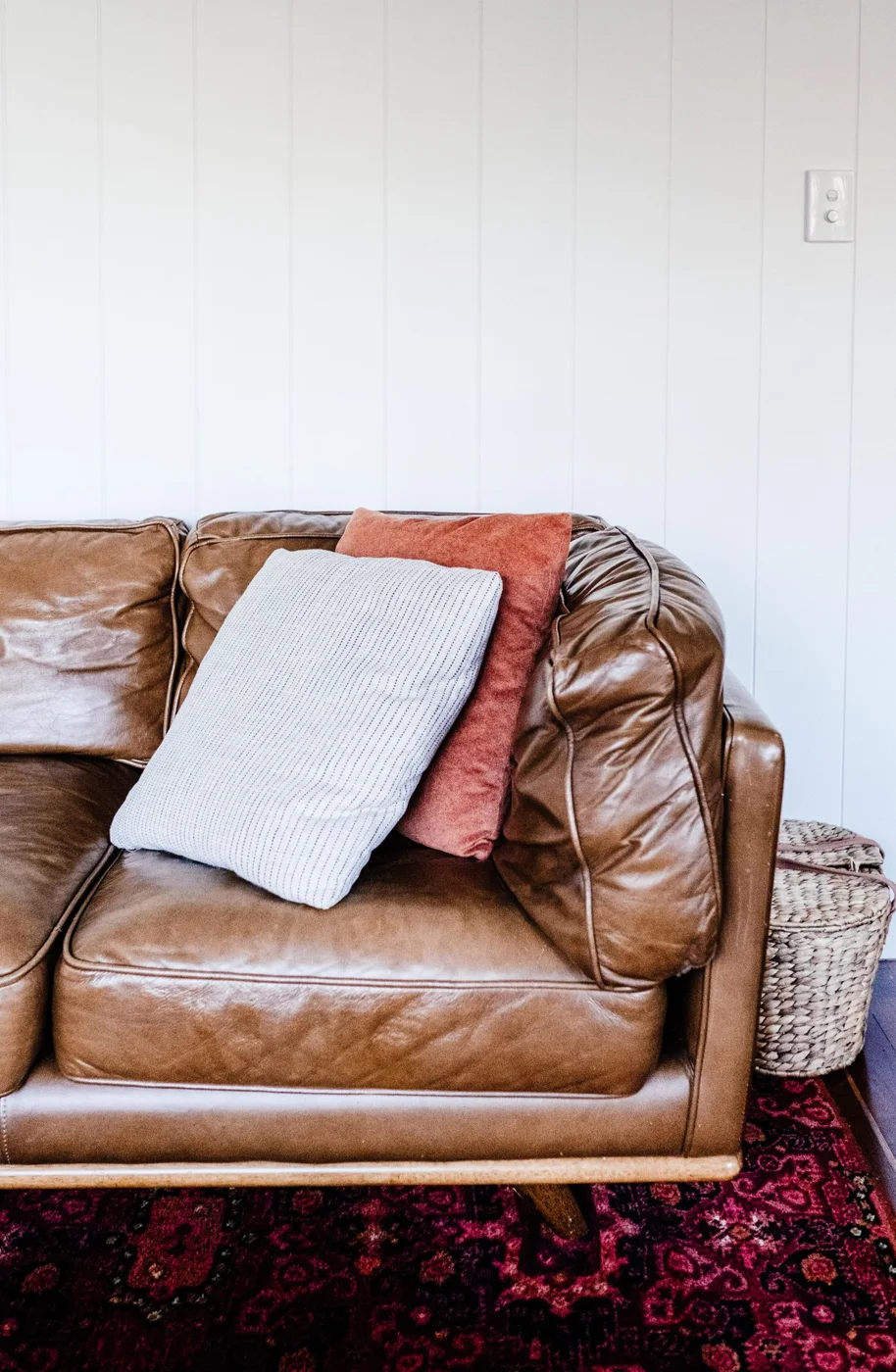 Leather sofa with cushions